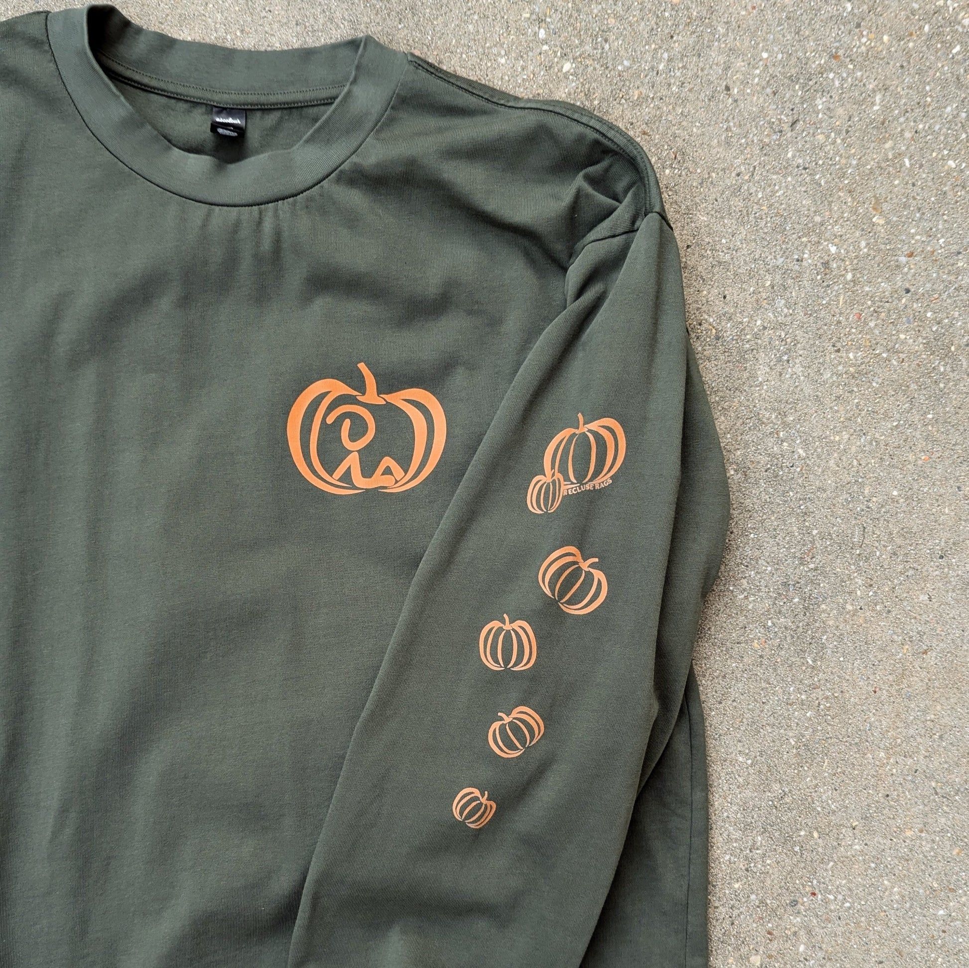 Closer view of chest and left sleeve design on Pumpkin Vibes shirt.