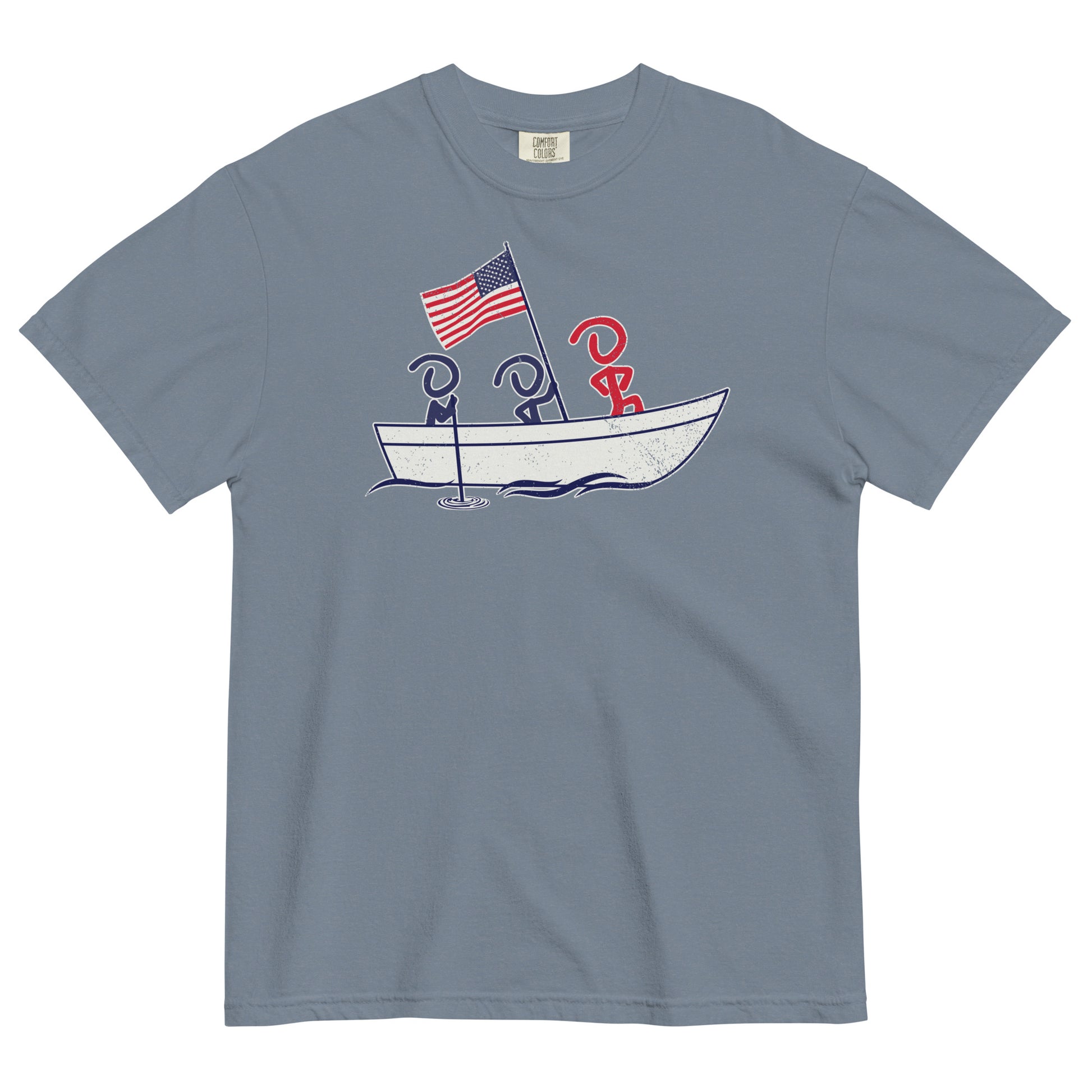 A gray blue short sleeve t-shirt laid flat. Front graphic shows three Jaunty Men in a simple boat carrying an American flag, similar to George Washington crossing the Delaware.