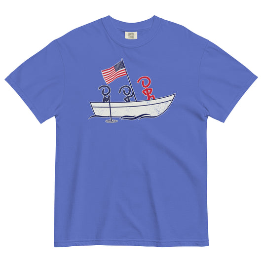 A blue short sleeve t-shirt laid flat. Front graphic shows three Jaunty Men in a simple boat carrying an American flag, similar to George Washington crossing the Delaware.