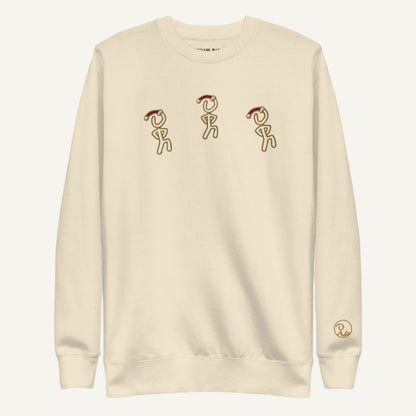 Front view of sweatshirt featuring Christmas-themed Jaunty Man figure in a Santa hat.