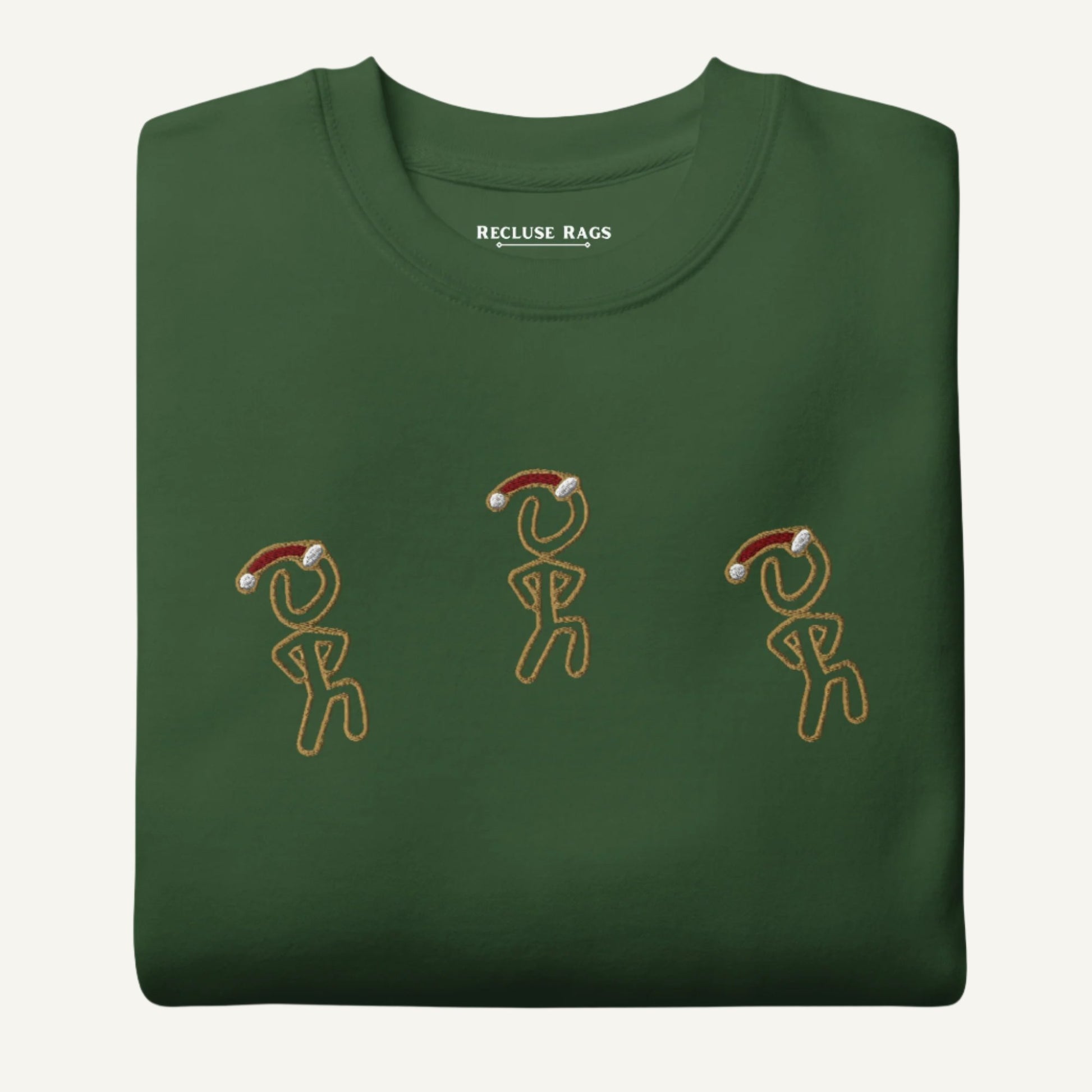 Folded view of sweatshirt featuring Christmas-themed Jaunty Man figure in a Santa hat.