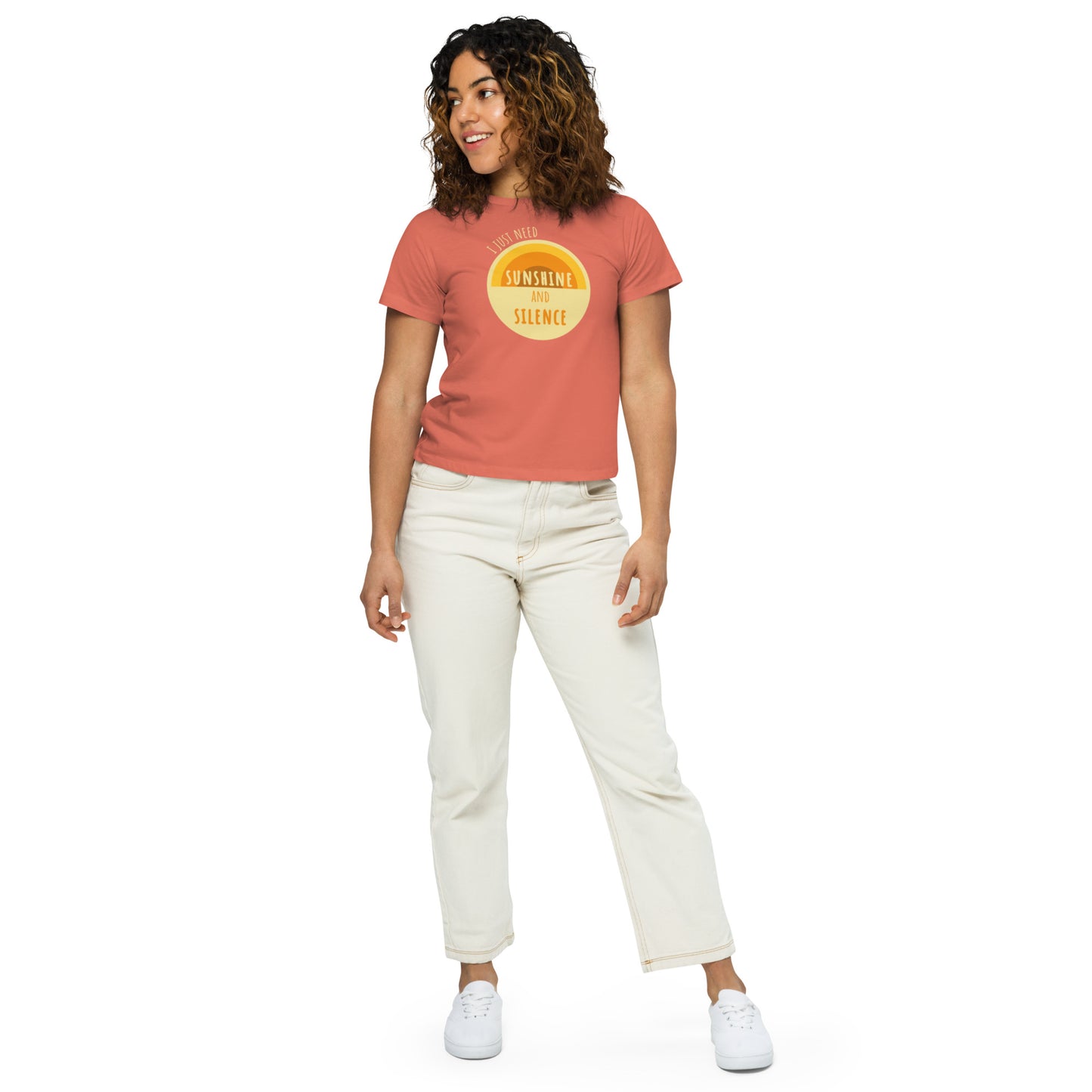 Woman posing in red sorbet premium high-waisted t-shirt. "I just need sunshine and silence" written atop a light yellow circle with a semi-circular sun design.